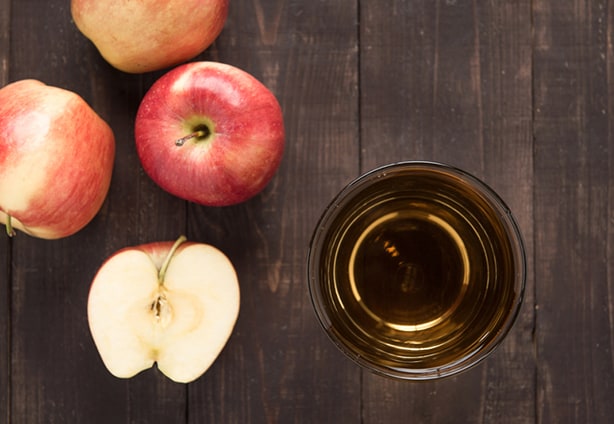 Top healthy apple juice drink and red apples fruits on wooden ba Top view healthy apple juice drink and red apples fruits on wooden background.