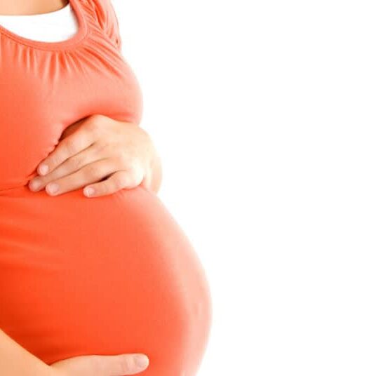 Pregnant woman resting her hands on her stomach