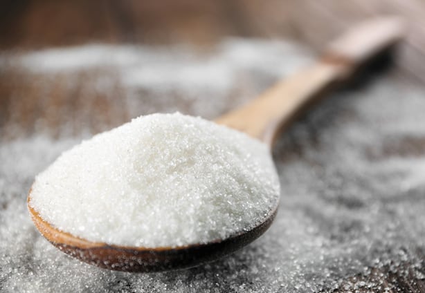 Spoon with white sugar on wooden background Spoon with white sugar on wooden background