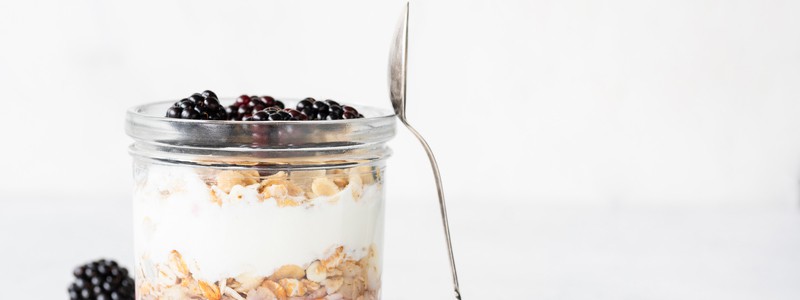 Yogurt parfait with blackberries and granola in a jar Yogurt parfait with blackberries and granola in a jar. Healthy breakfast, overnight oats or snack. Copy space for text